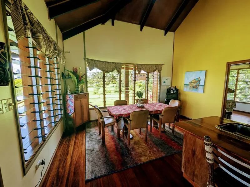 Dining table beside a wall of windows